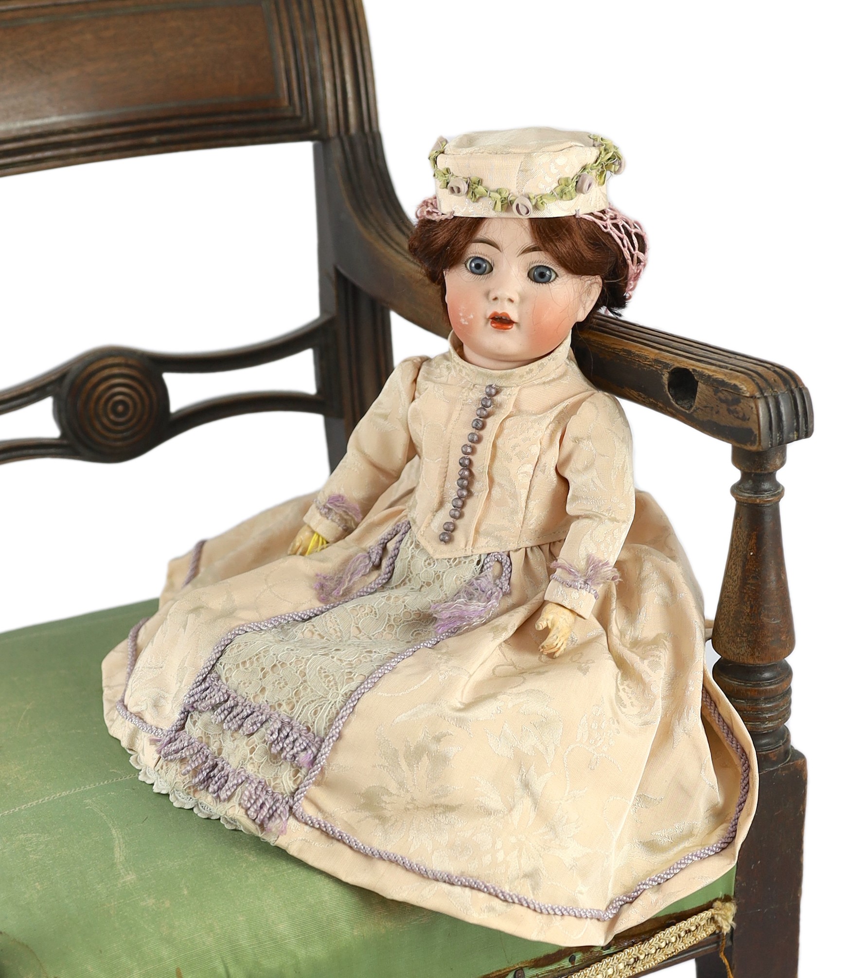 A Kammer & Reinhardt / Simon & Halbig bisque character doll, German, circa 1911, 13in. Please note the chair is for display purposes only.